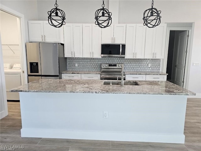 kitchen with white cabinets, hanging light fixtures, and stainless steel appliances