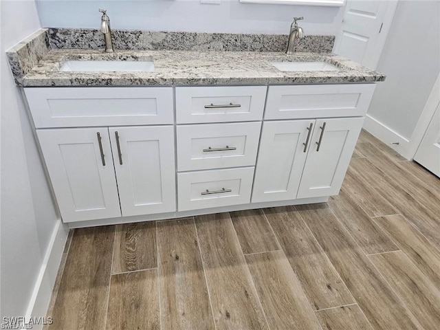 bathroom featuring vanity and hardwood / wood-style floors