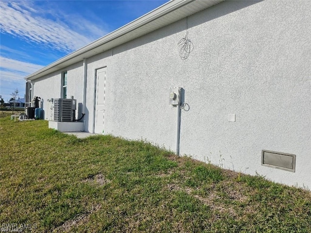 view of home's exterior featuring central AC and a lawn