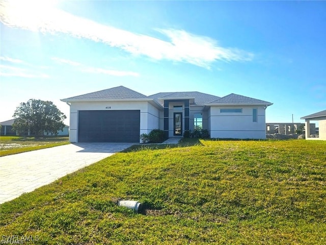 view of front of house with a front lawn and a garage