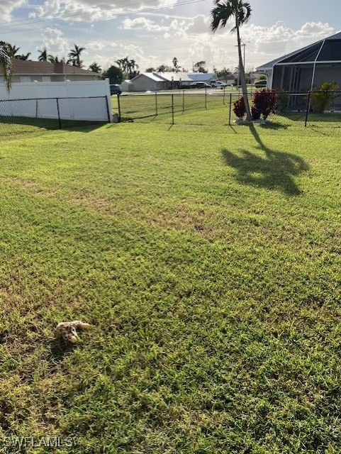 view of yard featuring glass enclosure