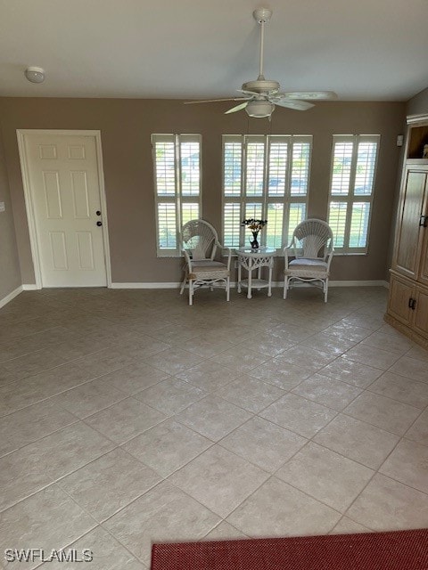 unfurnished room featuring a wealth of natural light, light tile patterned flooring, and ceiling fan