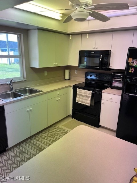 kitchen with sink, black appliances, white cabinets, and ceiling fan