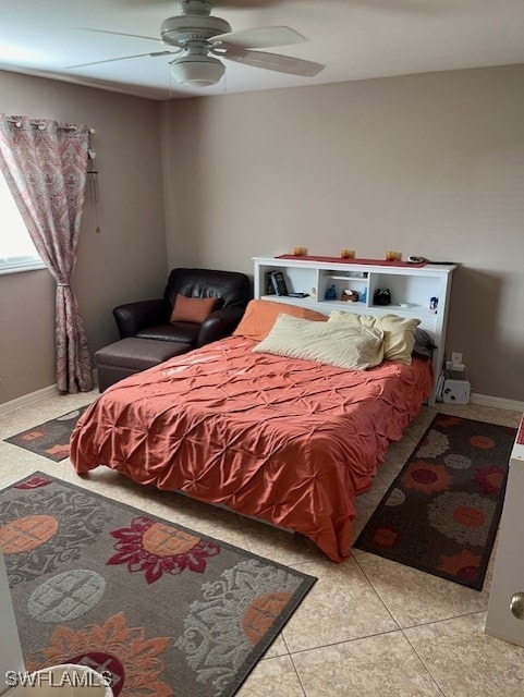 tiled bedroom featuring ceiling fan