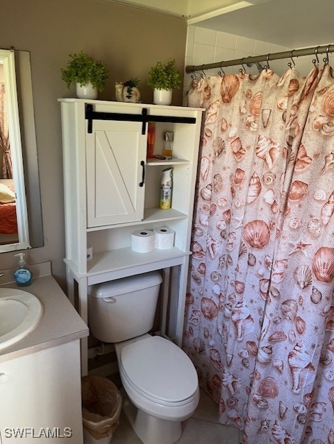 bathroom with vanity, a shower with curtain, toilet, and tile patterned floors