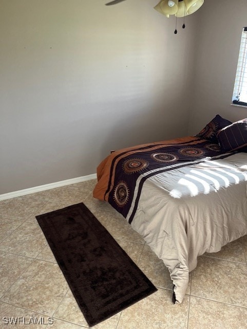 bedroom featuring light tile patterned floors and ceiling fan