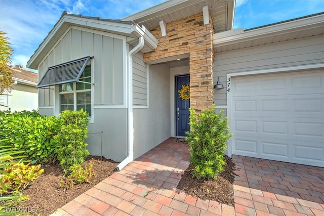 doorway to property with a garage