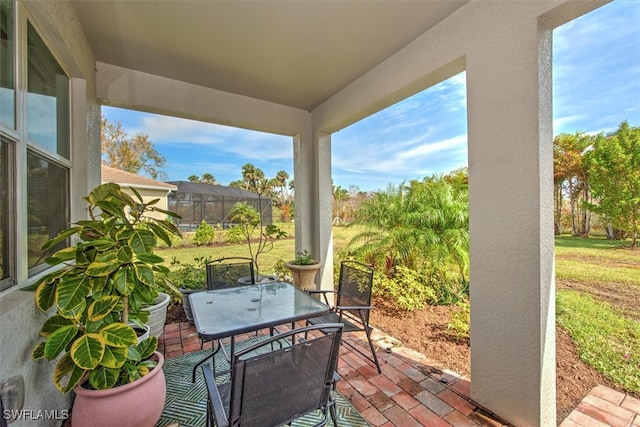 view of patio featuring a lanai