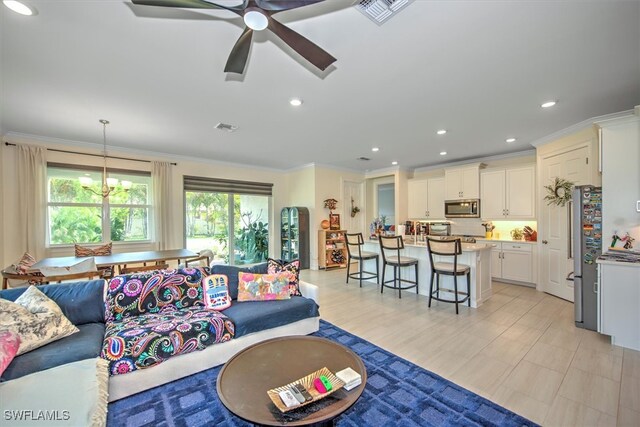 living room featuring crown molding and ceiling fan