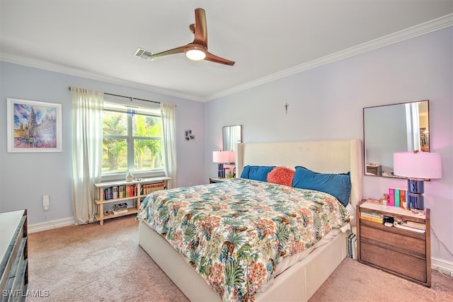 bedroom featuring ornamental molding, light colored carpet, and ceiling fan