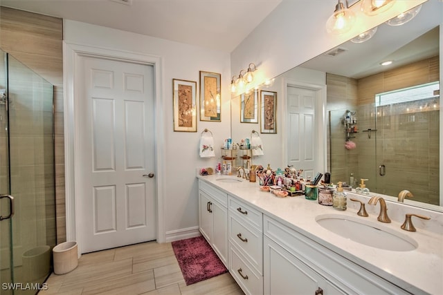 bathroom featuring vanity and an enclosed shower