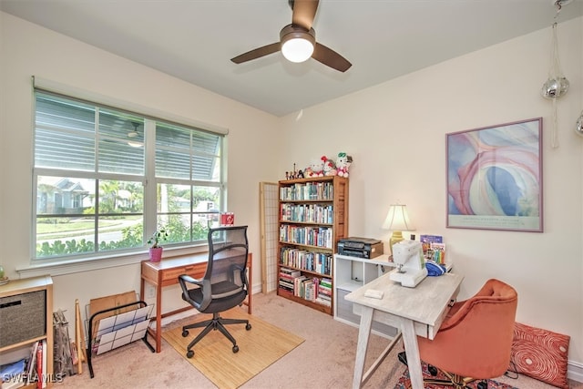 carpeted office space with ceiling fan