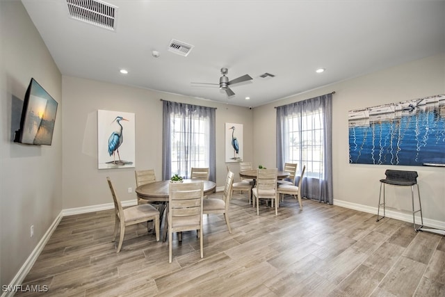 dining area with light hardwood / wood-style floors, a healthy amount of sunlight, and ceiling fan