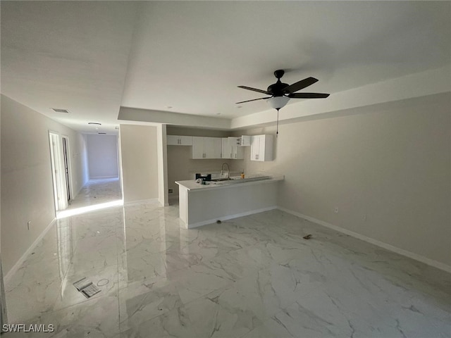 interior space featuring ceiling fan and sink