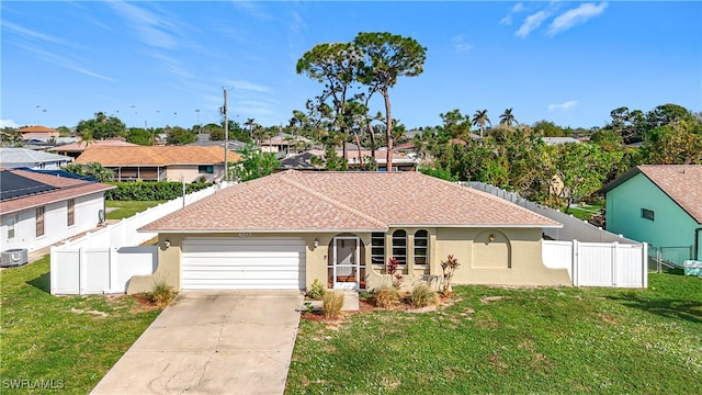 ranch-style house with central AC unit, a garage, and a front lawn