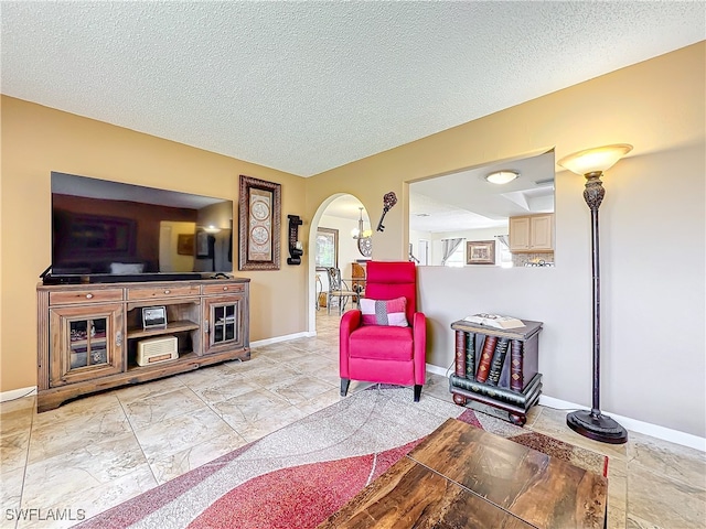 living area featuring a textured ceiling