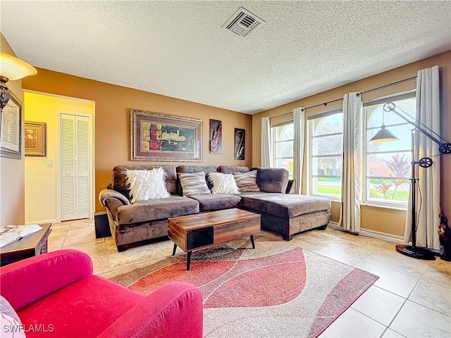 tiled living room featuring a textured ceiling