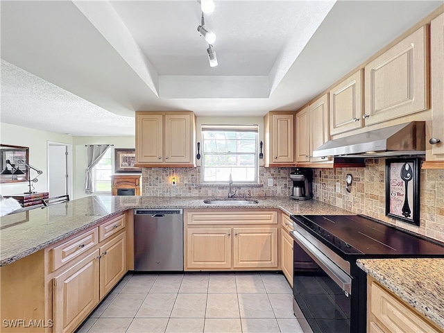 kitchen featuring a wealth of natural light, sink, light tile patterned flooring, and appliances with stainless steel finishes