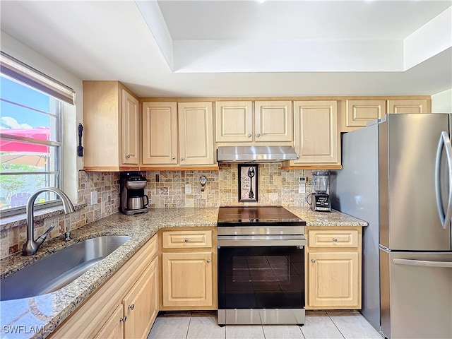 kitchen featuring light brown cabinets, sink, light tile patterned floors, and stainless steel appliances