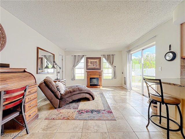 living room with a textured ceiling and light tile patterned flooring