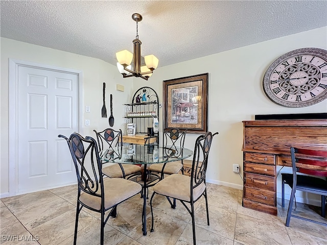 dining space with a chandelier and a textured ceiling