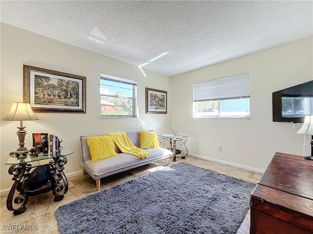 sitting room featuring a healthy amount of sunlight and a textured ceiling