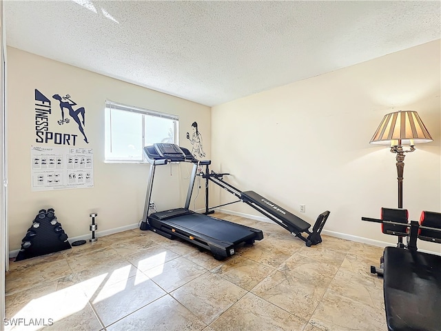 workout area featuring a textured ceiling