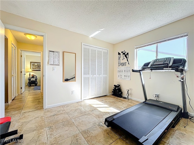 workout area featuring a textured ceiling