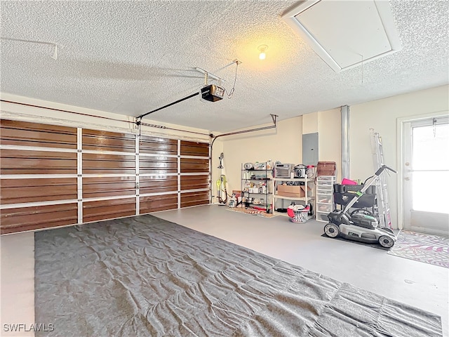 garage featuring electric panel and a garage door opener