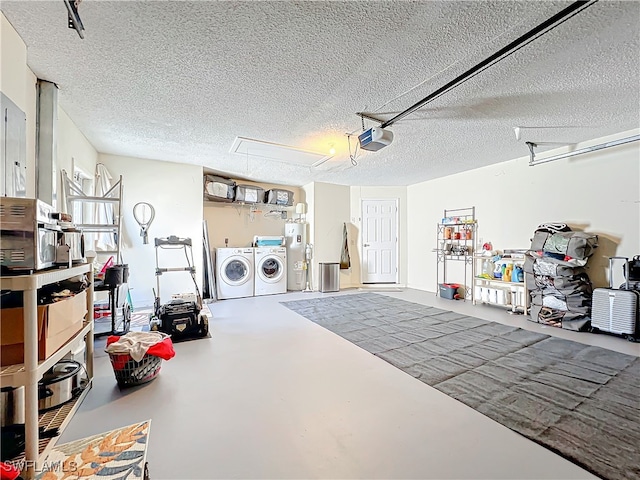 garage featuring water heater, washer and clothes dryer, and a garage door opener