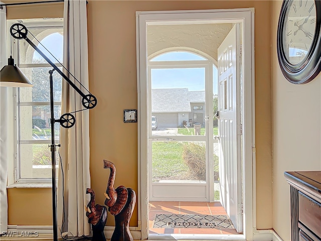 doorway with tile patterned floors