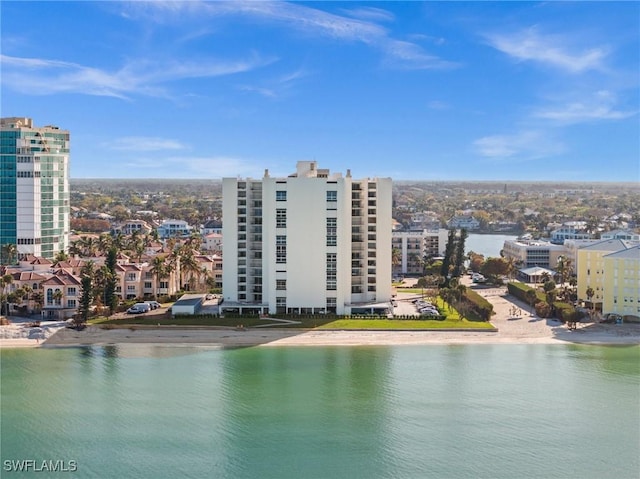 drone / aerial view featuring a city view and a water view