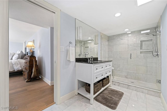 bathroom featuring vanity, an enclosed shower, and wood-type flooring