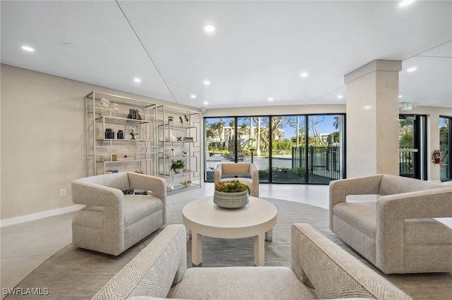 tiled living room featuring recessed lighting, a wealth of natural light, and baseboards