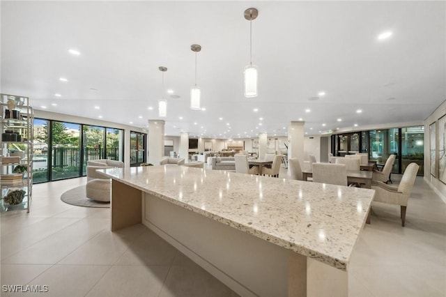 kitchen featuring recessed lighting, expansive windows, open floor plan, and a large island
