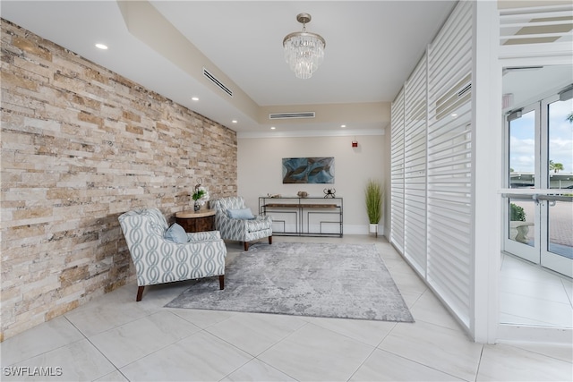 living area with light tile patterned flooring and an inviting chandelier