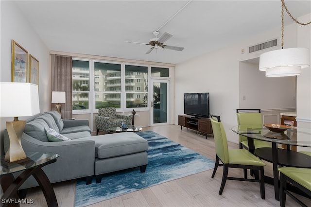 living room featuring light hardwood / wood-style floors and ceiling fan