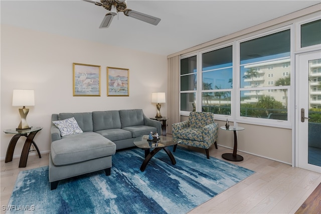 living room featuring wood-type flooring and ceiling fan