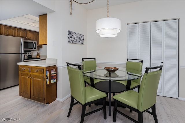 dining room with light wood-type flooring