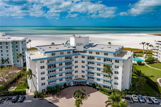 bird's eye view featuring a view of the beach and a water view