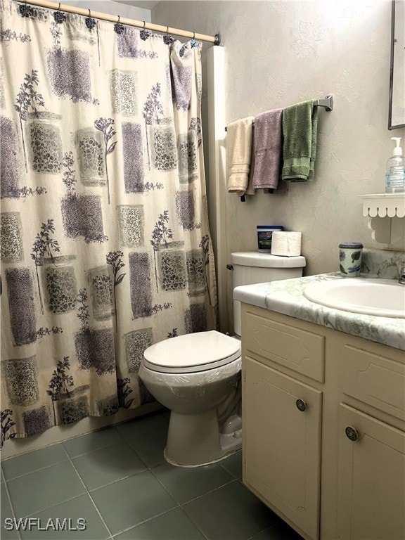 bathroom with vanity, toilet, a shower with curtain, and tile patterned flooring