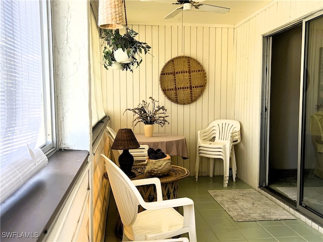 interior space with ceiling fan