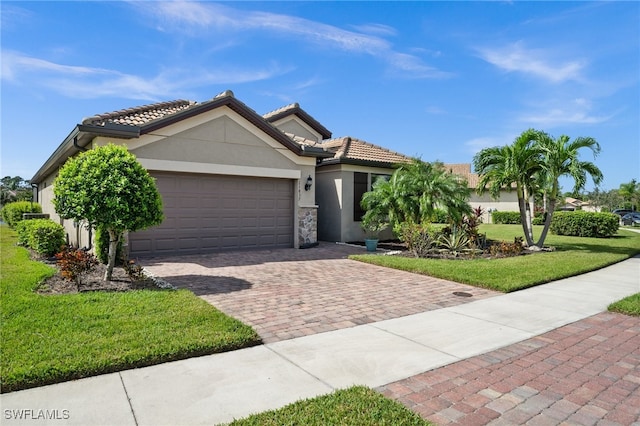 view of front of house featuring a front yard and a garage