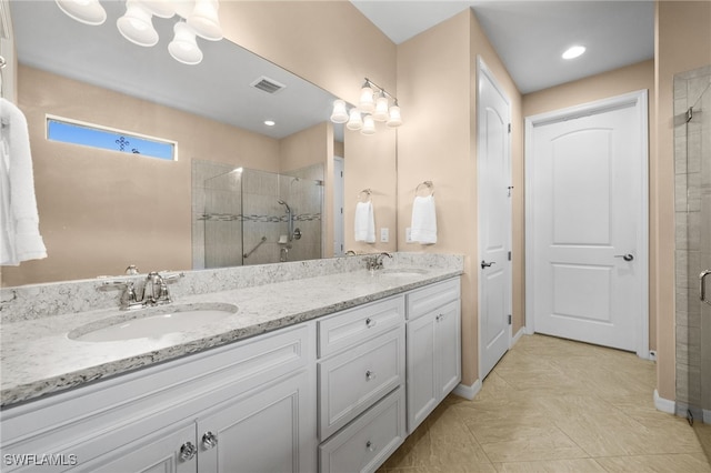 bathroom featuring vanity and an enclosed shower