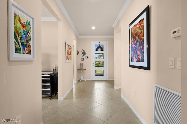 hallway with light tile patterned floors and ornamental molding