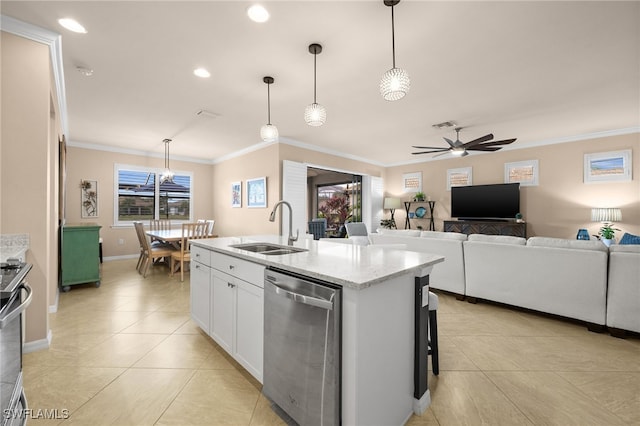 kitchen with a healthy amount of sunlight, white cabinetry, stainless steel appliances, and an island with sink