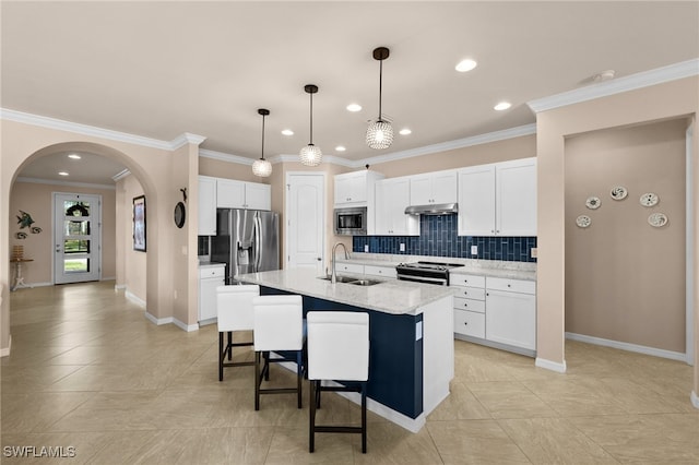 kitchen featuring a center island with sink, white cabinets, crown molding, sink, and appliances with stainless steel finishes