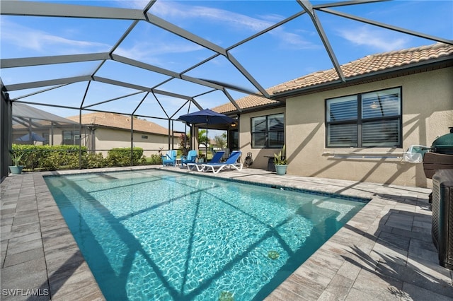 view of swimming pool with a lanai and a patio area