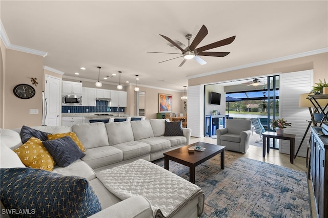 tiled living room with ceiling fan, crown molding, and sink