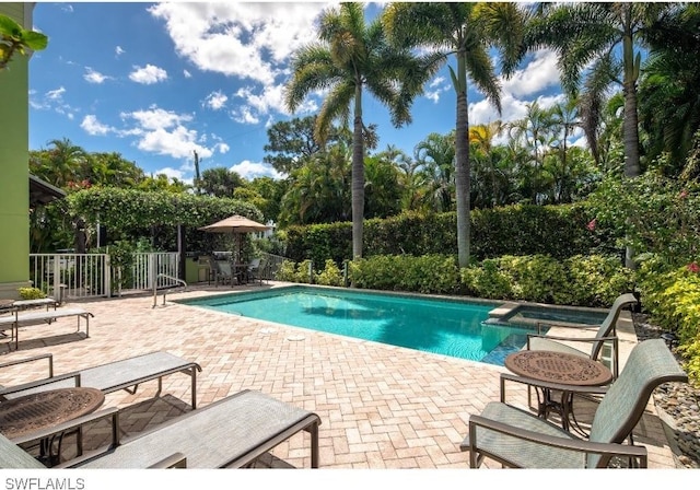 370 11th Ave S Unit 2, Naples, FL 34102 - view of swimming pool with a patio and a pool with connected hot tub